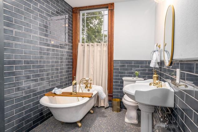Blue subway tile bathroom with penny tile floors